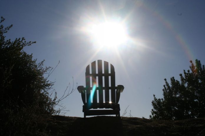 Summer sun shining through the slats of a garden chair